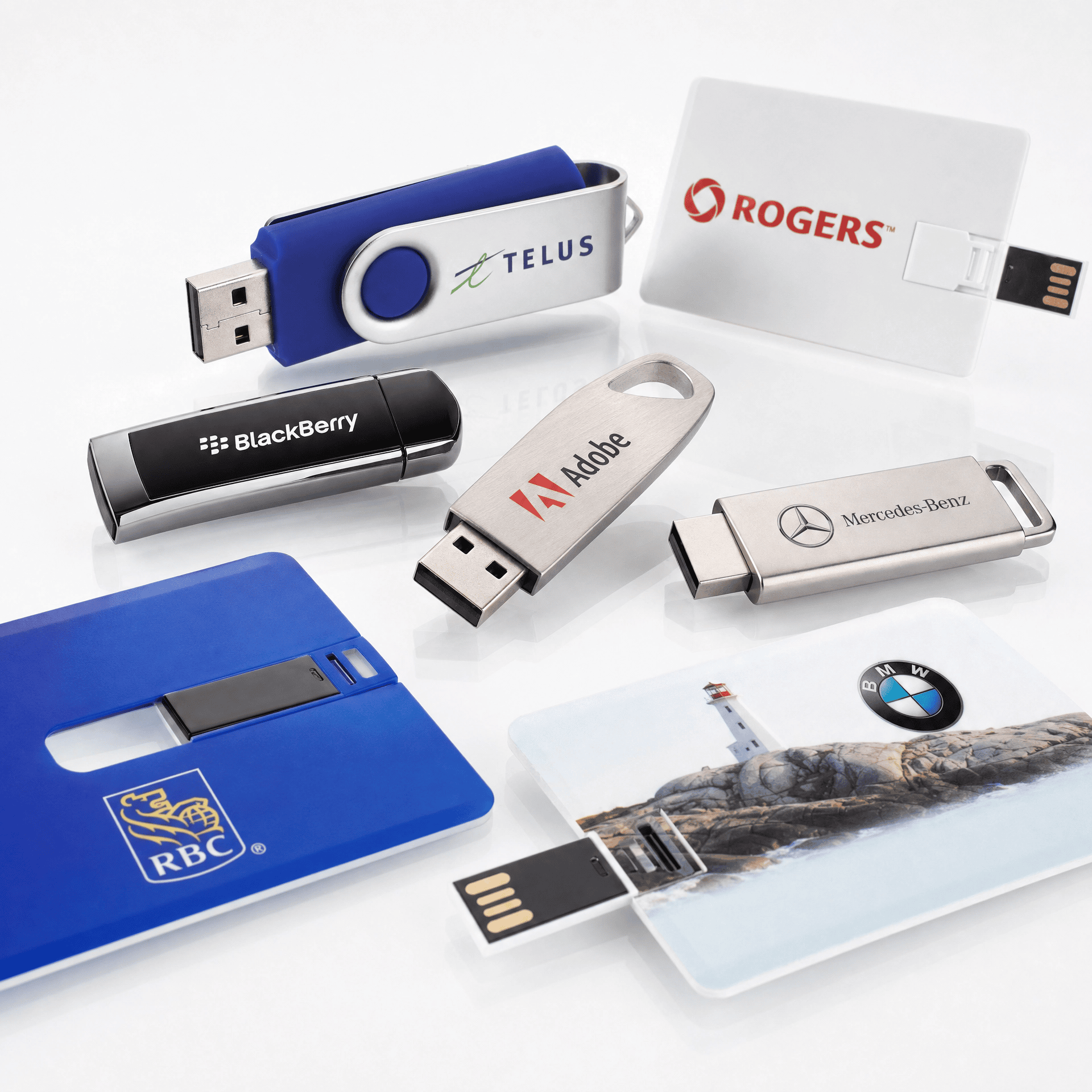 Variety of branded USB flash drives with company logos for promotional use.